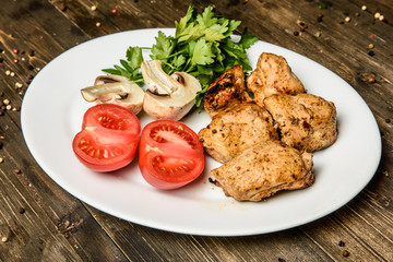 Sausages on the grill pan the wooden background. Top view