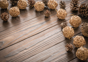 Rustic wood background with pine cones. Dark brown colors.