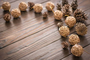 Rustic wood background with pine cones. Dark brown colors.