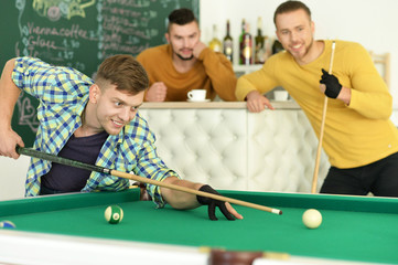 Men play billiard