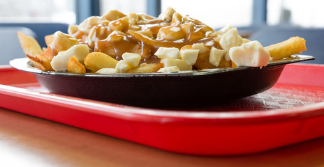 Close shot of a poutine - Famous meal from the province of Quebec - Shallow depth of field