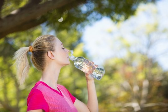 Woman drinking water from water bottle