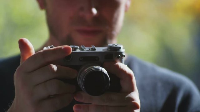 Male tourist holding hands in a retro camera