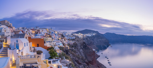 cityscape of Oia, traditional greek village of Santorini at sunset, Greece