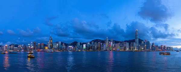 Evening panoramic view of the lighted Victoria Harbour in Hong Kong