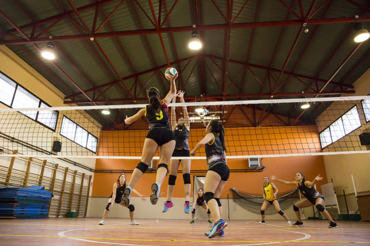 Women playing volleyball match