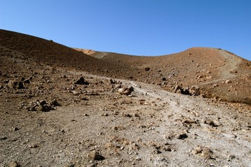 Volcano crater with focus on rocks in a sunny day, Italy