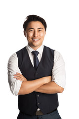 A trendy and fashionable businessman wearing a blue vest, tie and shirt. Standing against a white background smiling.