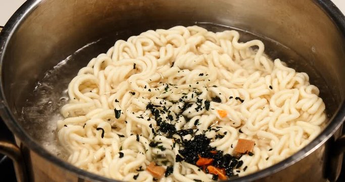Cooking of korean noodle named ramyeon in boil.