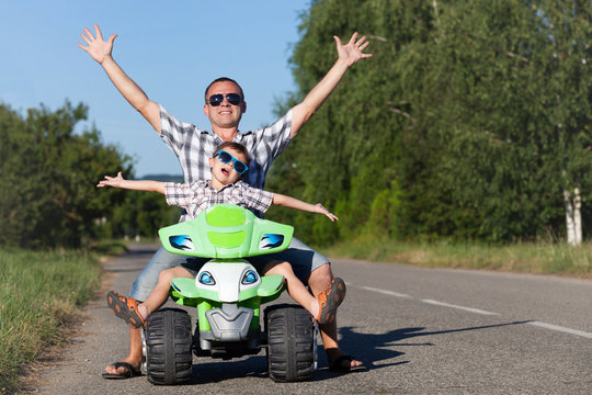 Father and son playing on the road at the day time. © altanaka