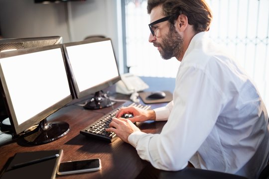 Businessman with glasses working on computer 