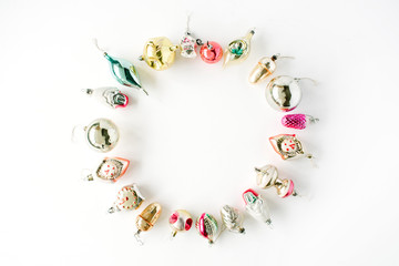 creative arrangement frame of bright christmas balls and toys on white background. flat lay, top view