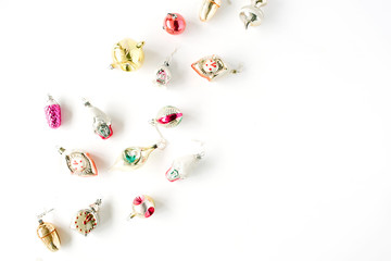 creative arrangement of bright christmas balls and toys on white background. flat lay, top view