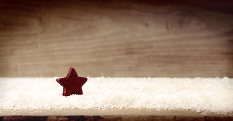 Christmas wooden background with red star .