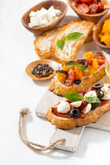 bruschettas with tomatoes and mozzarella on wooden board