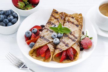 crepes with berries and chocolate sauce for breakfast