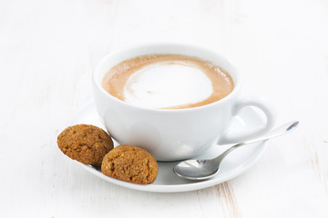 cup of cappuccino and flavored cookies, selective focus
