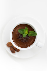 cup with hot chocolate decorated with mint, vertical, top view
