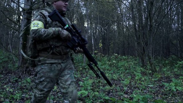 soldier with a sniper rifle in the forest are
