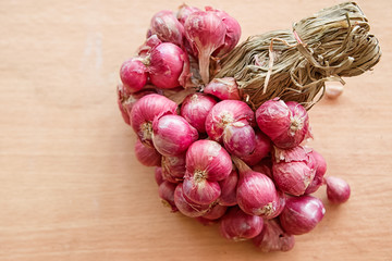 Bunch of red onions on wooden background