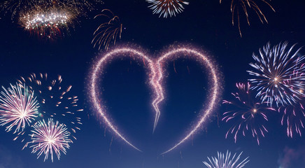 Night sky with fireworks shaped as a broken heart.(series)