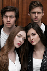 Fototapeta premium Young elegant trendy friends outdoors, wearing black and white clothing