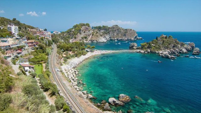 Sicily Island Coast at Taormina Italy at Isola Bella Beach with Hillside and Railroad Bordering the Blue Mediterranean Sea Water on a Sunny Day in Europe