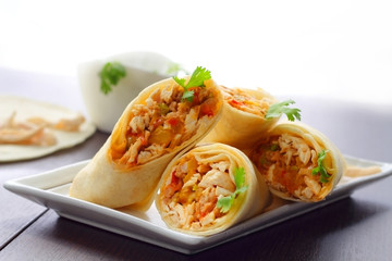 Burritos wraps with chicken and vegetables.