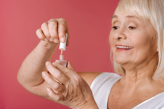 Content Retired Woman Using Nail Varnish