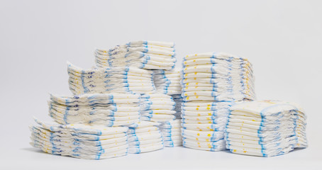 Diapers stacked in a piles close up.