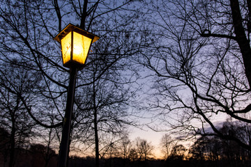 Yellow lantern in front of blue sky during blue hour.