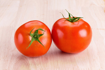 tomatoes on wooden background.