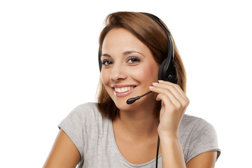 attractive and happy young woman with headset on her head