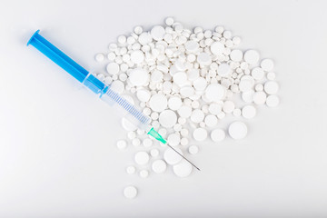 Bunch of white pills with green injection. Scattered pills