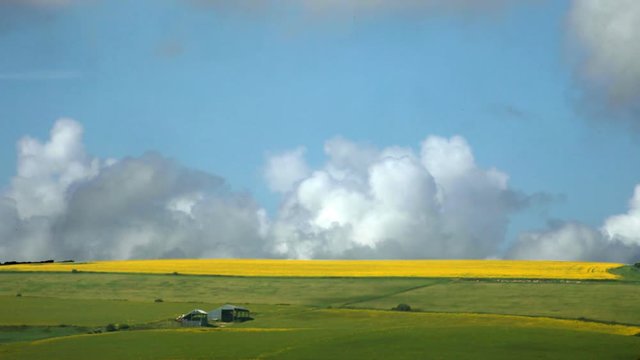 rolling hills and time lapse clouds view over fields