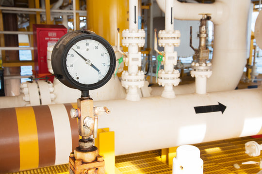 pressure gauge,pressure gauge measuring gas pressure. Pipes and valves at oil and gas industrial plant.
