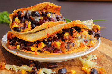 Taco with beans cheese and vegetable.