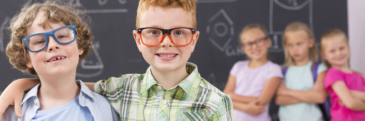 Happy school friends wearing new glasses