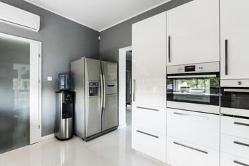 Stylish open plan kitchen with silver fridge