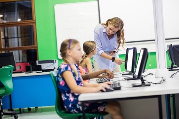 Teacher giving lesson to her students with technology