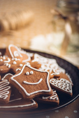 Smiling gingerbread star on plate, shallow dof.