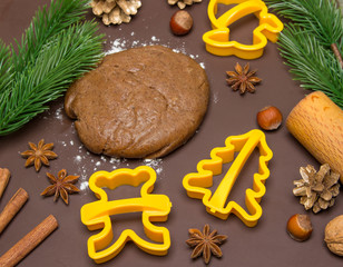 Christmas baking gingerbread, background: dough, flour and cookie cutters.