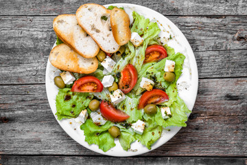 Greek salad, vegetable salads, top view on plate, vegetarian food