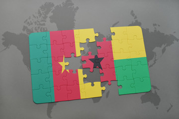 puzzle with the national flag of cameroon and guinea bissau on a world map.