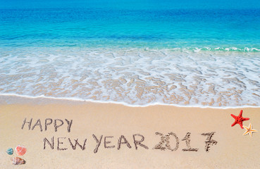 happy new year 2017 written on the beach