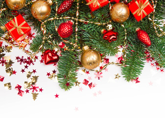 Christmas or New Year background: fur-tree, branches, gifts, colored glass balls and toys, decoration on a white background