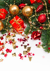 Christmas or New Year background: fur-tree, branches, gifts, colored glass balls and toys, decoration on a white background