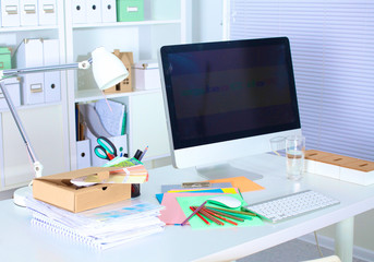 Fototapeta na wymiar Designer working desk with a computer and paperwork