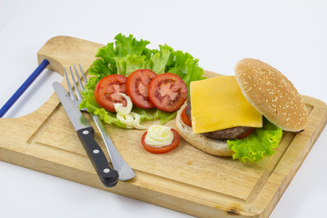 burger made from vegetables and beef on white background / hamburger with vegetables and fries on a wooden board, top view on white background.
