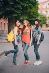 three young girls walking in the park